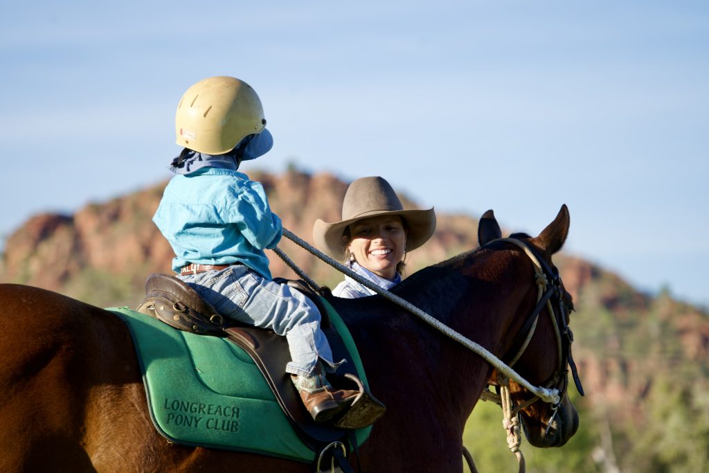 Boy and mom on horse in front of kelly's knob