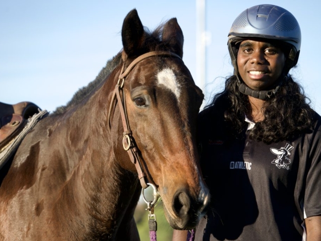 A young woman with her horse in Kununurra WA