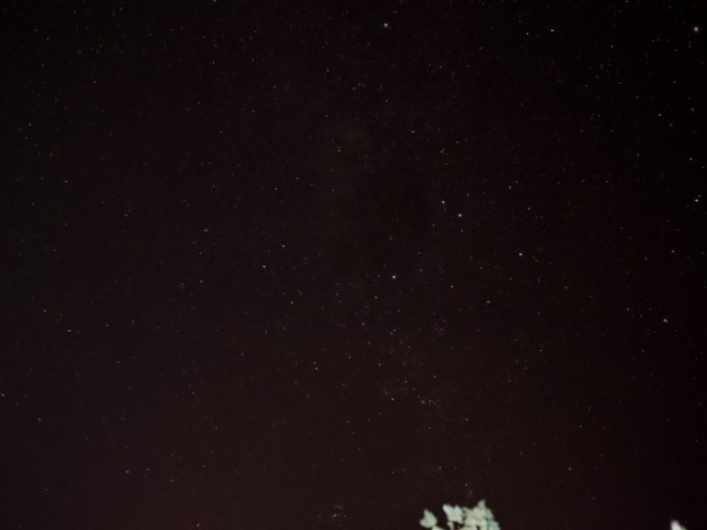 Cotton field at night with sandalwood burning creating red night sky