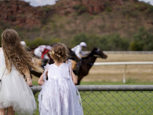 two girls watch the horse races in Kununurra WA