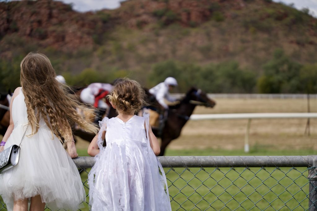 two girls watch the horse races in Kununurra WA