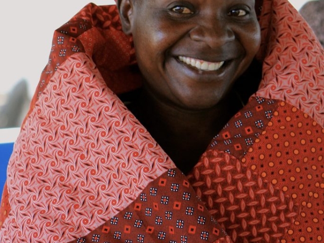 botswana woman wrapped in hand-sewn quilt made with german-print fabric