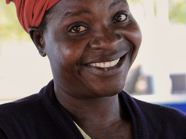 woman in pandamantenga botswana showcasing a hand-sewn quilt